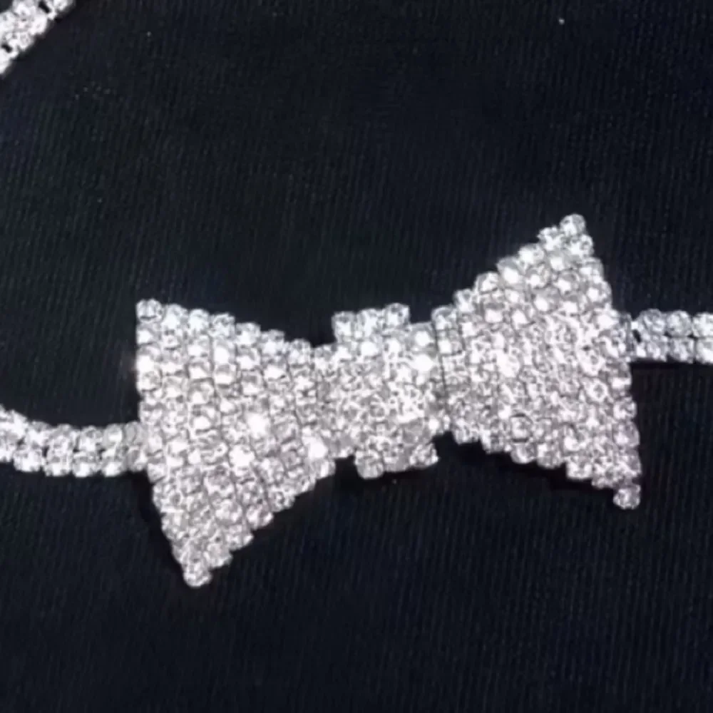 Dazzling crystal bow centerpiece on a sparkling choker. Elegant, eye-catching.